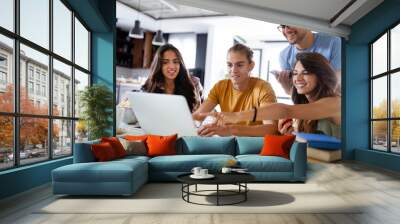 Happy group of students studying and working together in a college Wall mural