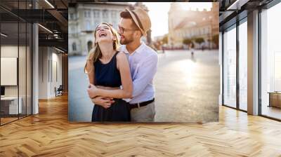 Happy romantic couple in love having fun outdoor in summer day Wall mural