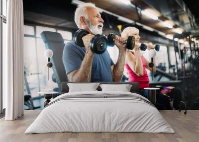 Happy senior people doing exercises in gym to stay fit Wall mural