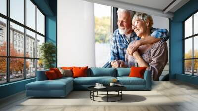 happy smiling senior couple embracing together at home Wall mural