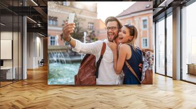 Happy tourist couple in love having fun, travel, smiling on vacation Wall mural