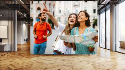 Happy traveling tourists sightseeing with map in hand Wall mural