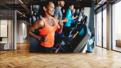 Happy woman smiling and working out in gym Wall mural