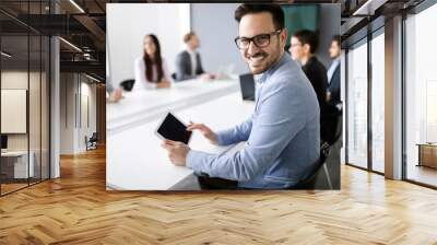 Happy young business colleagues in modern office Wall mural