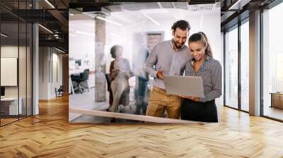 Happy young business people colleagues talking working in office Wall mural