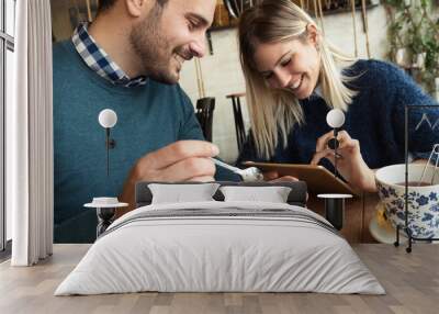 Happy young couple on date in coffee shop Wall mural