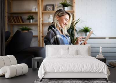 Happy young woman using tablet pc in loft apartment Wall mural