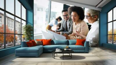 Image of business partners discussing documents and ideas Wall mural