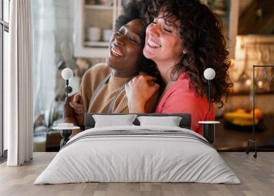 LGBT Lesbian couple love happiness concept. Homosexual women hugging and enjoying time together. Wall mural