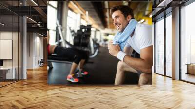 Lifestyle portrait of handsome muscular man after the training in the sport gym Wall mural