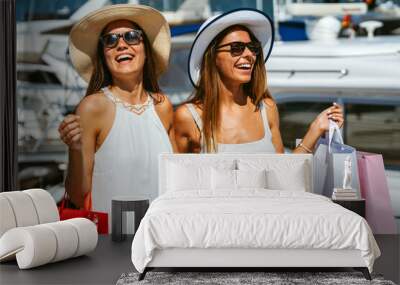 Luxurious life for two women walking and shopping on summer vacation. People travel fun concept. Wall mural