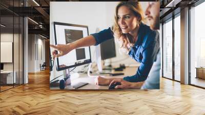 Man and woman working on computer in office Wall mural