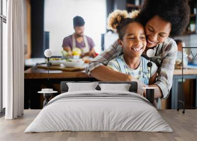 Mother and child having fun preparing healthy food in kitchen Wall mural