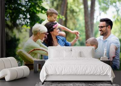 Multi generation family enjoying picnic in a park Wall mural