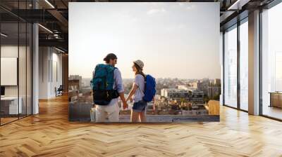 Multiethnic traveler couple using map together on sunny day Wall mural