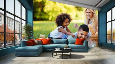 Picture of lovely couple with their daughter having picnic Wall mural