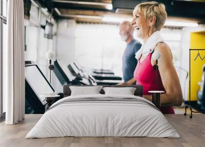 Picture of senior people running on treadmill in gym Wall mural