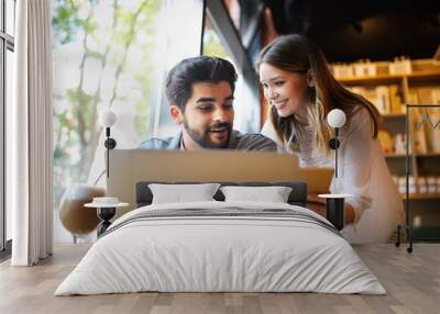 Portrait of a cheerful couple shopping online with laptop Wall mural