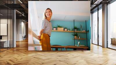 Portrait of beautiful young woman smiling and enjoying life Wall mural