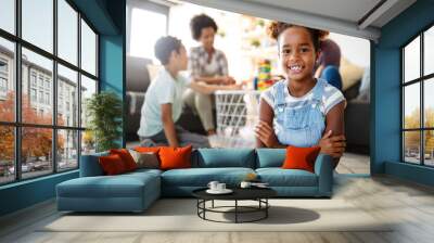 Portrait of black family playing a game at home together Wall mural