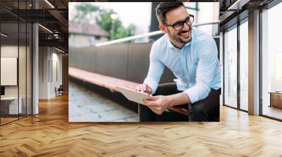 portrait of businessman in glasses holding tablet Wall mural