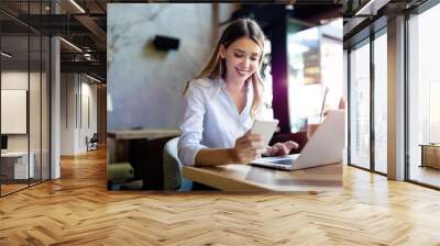 Portrait of cheerful coworker business woman working on laptop Wall mural