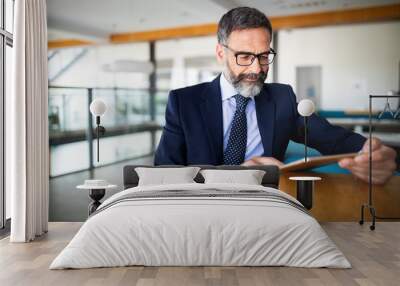 Portrait of handsome senior businessman with digital tablet in the modren office Wall mural