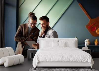 Portrait of happy businessmen using digital devices at meeting Wall mural