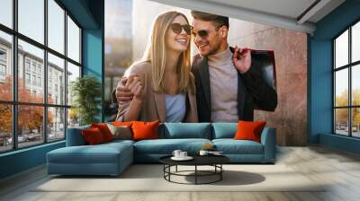 Portrait of happy couple with shopping bags. People sale consumerism and lifestyle concept. Wall mural