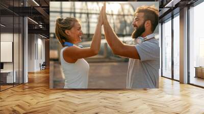 Portrait of happy fit sporty couple exercising and enjoying healthy lifestyle. People sport concept Wall mural