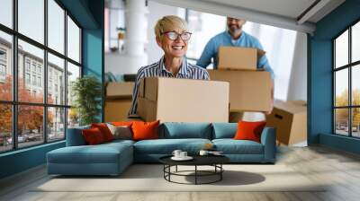 Portrait of happy senior couple in love moving in new home Wall mural