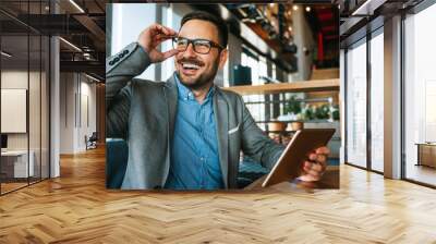 Portrait of happy succeffsul young business man, leader, ceo, manager using digital tablet to work. Wall mural