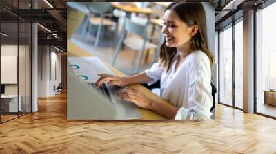 Portrait of happy success young woman working and smiling. Wall mural