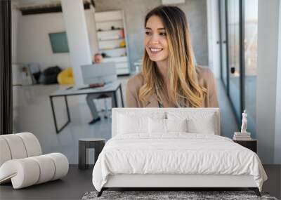 Portrait of smiling business woman in office working with tablet Wall mural