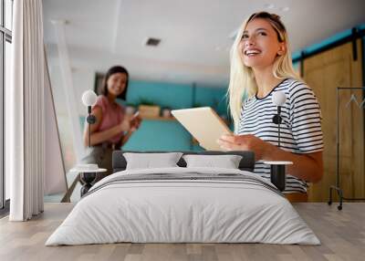 Portrait of smiling woman in office with tablet Wall mural