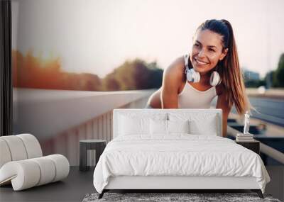 Portrait of woman taking break from jogging Wall mural