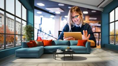 Portrait of young attractive woman using tablet Wall mural