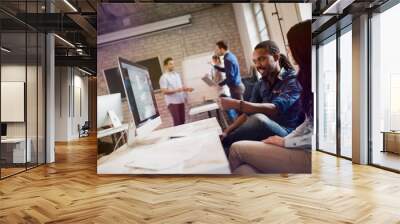 Portrait of young designers working on computer Wall mural