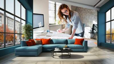 Portrait of young female architect working on project Wall mural