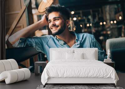 Portrait of young handsome man in blue shirt Wall mural