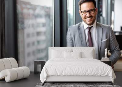 Portrait of young success business man with digital tablet in corporate office Wall mural