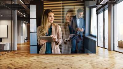 Professional business woman working with tablet in office Wall mural