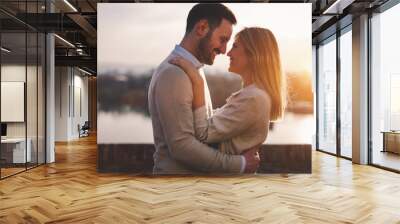 Romantic couple dating in sunset Wall mural