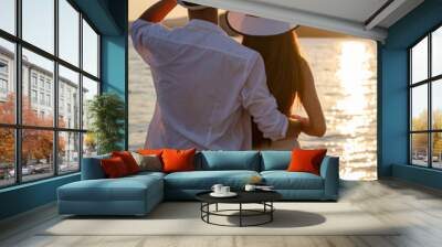 Romantic couple in love walking on beautiful beach on vacation Wall mural