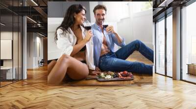 Sexy couple having a romantic dinner together in the bedroom Wall mural