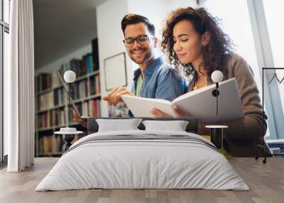 Students are studying together in library. Couple, study, technology, education love concept Wall mural