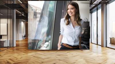 Successful business woman looking confident and smiling Wall mural