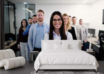 Successful team of young perspective businesspeople in office Wall mural