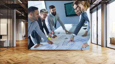 Team of architects working on construction plans Wall mural