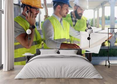 Team of construction engineers working on building site Wall mural